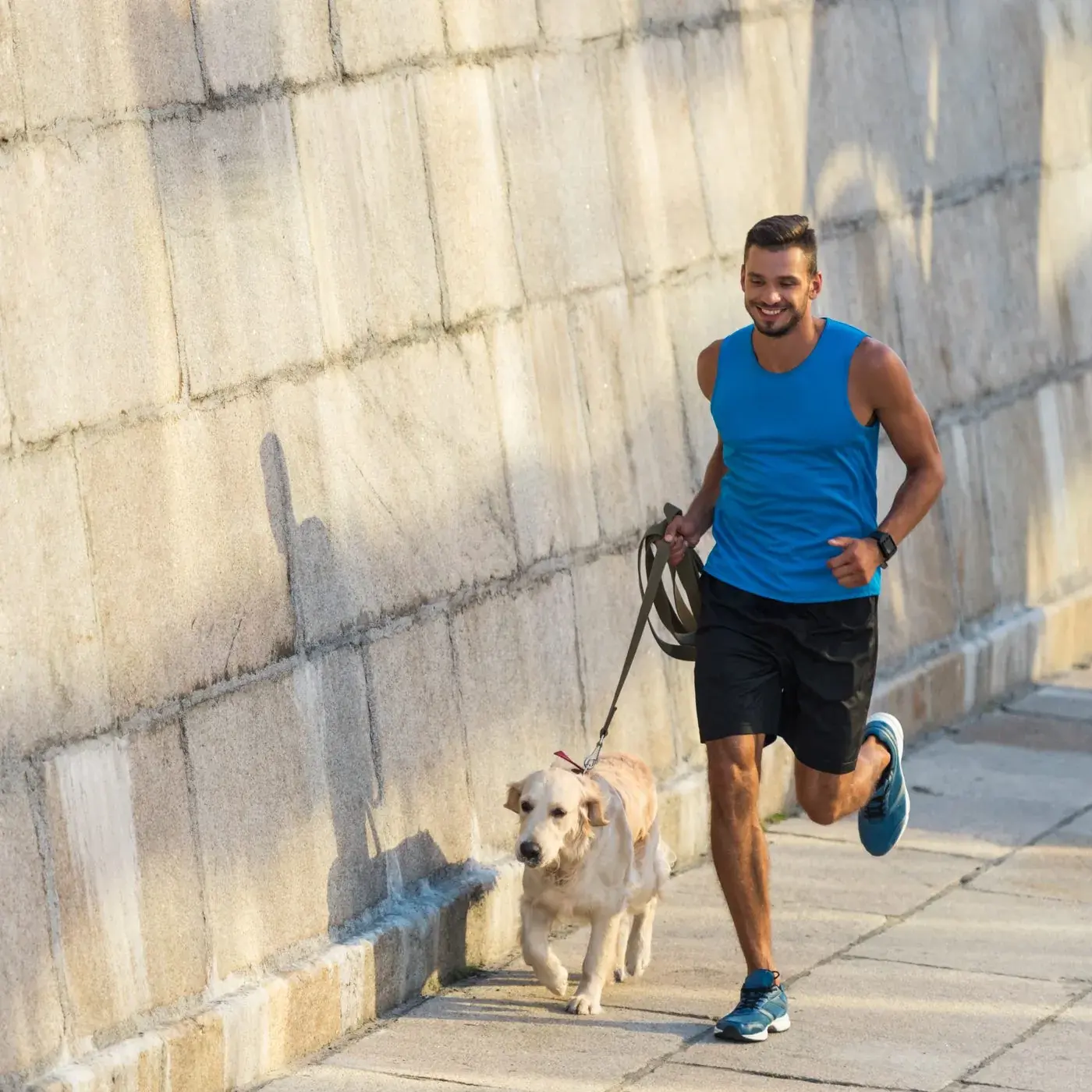 Man jogging with his dog along the waterfront