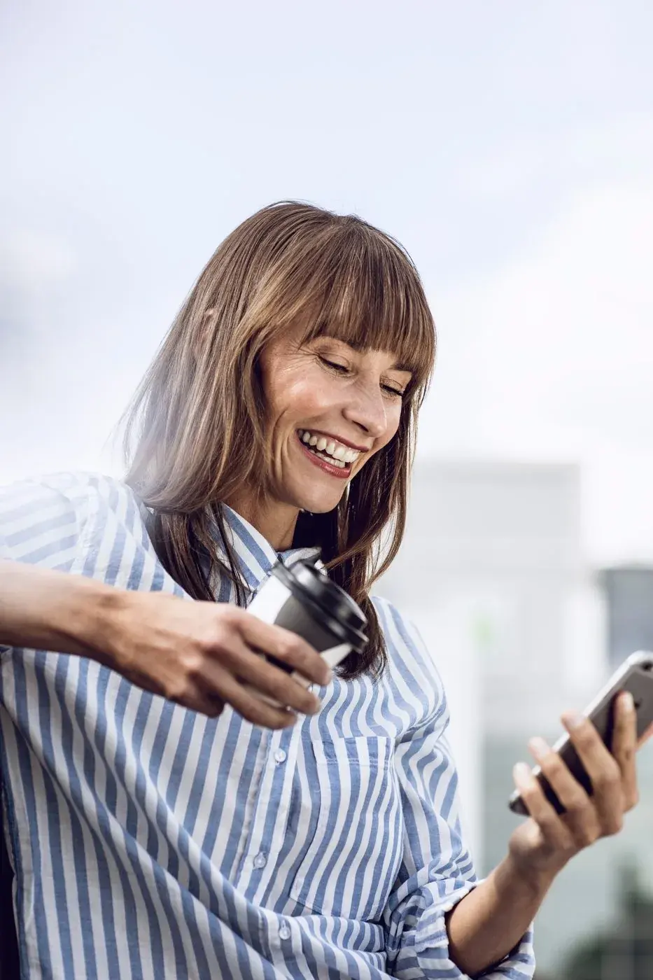 Smiling woman looking at her phone