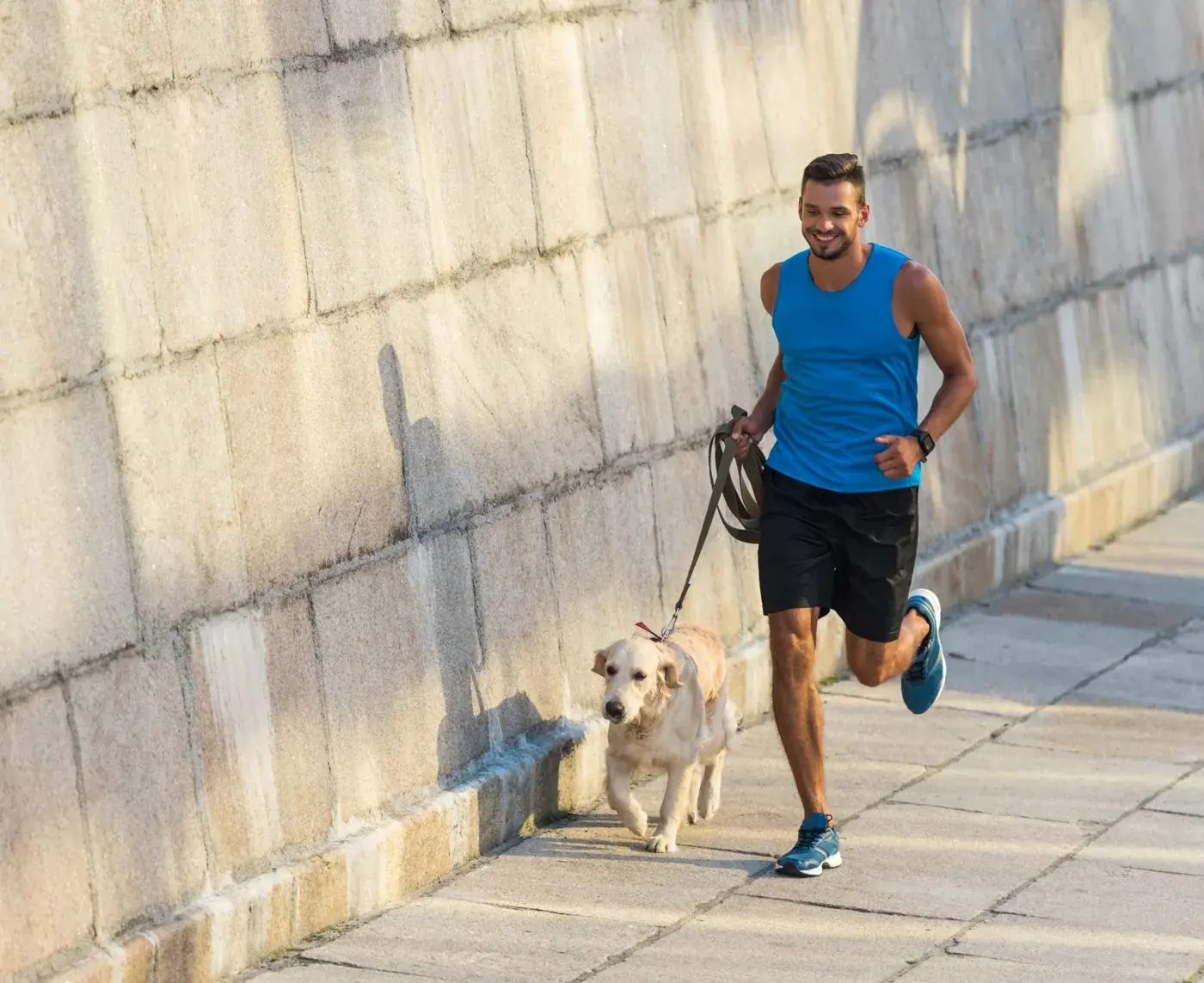 Man jogging with his dog along the waterfront